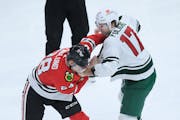 Minnesota Wild’s Marcus Foligno (17) fights Chicago Blackhawks’ Andreas Englund (28) during the third period. Foligno was ejected for holding Engl