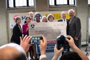 Elected officials posed with a ceremonial check for $239,345,549 on Tuesday, April 11, in St. Paul. Federal Transit Administrator Nuria Fernandez anno