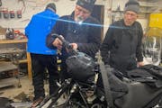 Paul Dick, 72, Rob Hallstrom, 65, and Rex Hibbert, 70, repair one of their snowmobiles in Fort Yukon, Alaska.