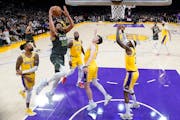 Timberwolves center Karl-Anthony Towns drove through a sea of Lakers during the first half of an NBA play-in game in Los Angeles on Tuesday.
