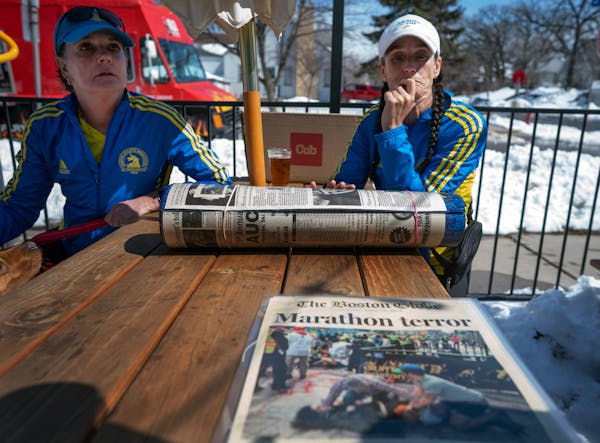 Jody Nelson, left, and Lisa Kresky-Griffin met April 2 with others who ran the 2013 Boston Marathon and looked over coverage of the attack.