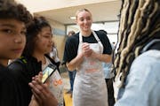 Paige Bueckers met with students before a grand opening ceremony for a new free grocery store at Hopkins West Junior High School.