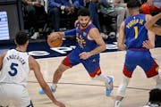 Jamal Murray of the Nuggets drove against the Timberwolves’ Kyle Anderson during the second quarter on Sunday night in Denver.