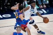 Wolves guard Anthony Edwards tried to drive past the Nuggets’ Jamal Murray in Game 1 on Sunday. Coach Chris Finch wants Edwards to be aggressive.