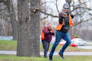 Cole Miska fires his full automatic blaster as he rushes forward during a “territories” game at a Minnesota Nerf community outing Saturday, April 
