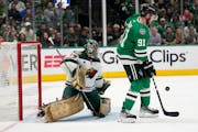 Dallas Stars center Tyler Seguin (91) pressures as Minnesota Wild’s Marc-Andre Fleury (29) defends against a shot in the first period.