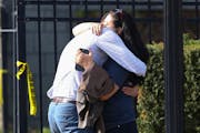 Two people embraced outside of a bank building where a workplace mass shooting took place in Louisville, Ky., Monday, April 10, 2023. 