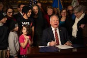 Gov. Tim Walz signed a federal tax conformity bill on Jan. 12 in the reception room at the State Capitol.