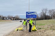 David Nelson, on the right, Brenna Everson, both of Minneapolis, pick up trash along Hwy. 169 in Hopkins.