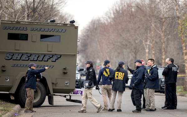 Law enforcement at the 3700 block of Dupont Avenue N. in Minneapolis on Thursday, where a 33-year-old man was shot in a standoff involving a SWAT unit