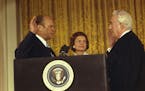Chief Justice Warren Burger administers the Oath of Office to President Gerald Ford while Betty Ford looks on.