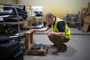 In the intake sorting area, Luke Kragenbrink, an environmental health and safety specialist, looked at a portable record player that Repowered’s St.