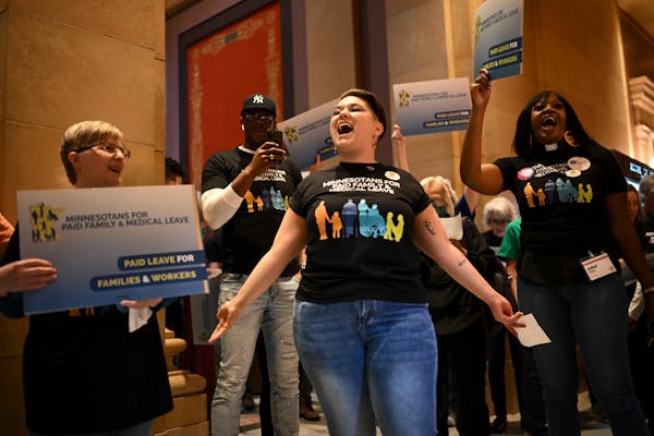Minnesota AFL-CIO organizer Haylee Hilton leads a rally in support of paid family leave Monday at the State Capitol.