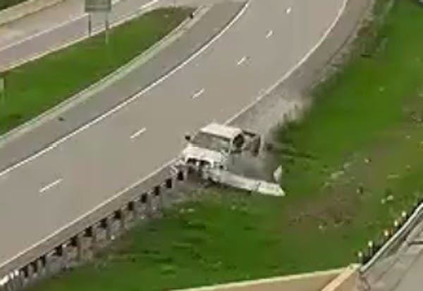 Pickup crashes into I-694 guard rail, barrel rolls over concrete wall to road below