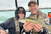 Scott Ward of Inver Grove Heights. right, and Jack Kennedy of Cottage Grove with an Opening Day walleye from Lake Sarah in Murray County. 