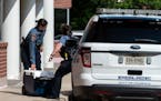 Officers work outside the Fairfax, Va., office building where police say a man wielding a baseball bat attacked and injured two staffers for U.S. Rep.