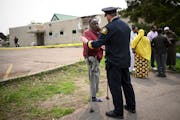 Mussa Jarso, member of the Tahwid Islamic Center community, speaks with St. Paul Police Deputy Chief Josh Lego near the burned out center Wednesday, M