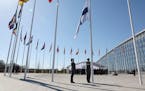 Military personnel raise the flag of Finland during a ceremony on the sidelines of a NATO foreign ministers meeting at NATO headquarters in Brussels, 