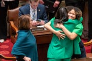 Sen. Lindsey Port, DFL-Burnsville, center, author of the marijuana bill, got a hug from Sen. Clare Oumou Verbeten, DFL-St. Paul, when the Senate passe