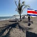 A Costa Rican flag flutters on the beach in downtown Puntarenas.