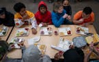 Fifth-graders eat lunch at Champlin-Brooklyn Park Academy for Math and Environmental Sciences in February.
