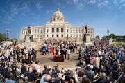 Along with DFL legislative leaders and his commissioners, Gov. Tim Walz threw a bill-signing party Wednesday morning on the Capitol steps.