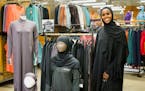 Muna Mohamed with her Kalsoni activewear line at the REI store in Roseville.