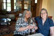 Mini Jain, left, her wife, Anne Robertson, and their dog Lance at home in Minneapolis.