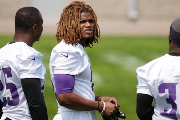 Vikings safety Lewis Cine, center, says he’s better as a player and person despite not playing much of last season.