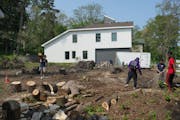 Students from the GAP School on May 23 cleared the next-door lot in St. Paul which will be their second home site once the first home is sold. They pu