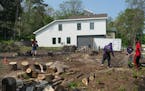 Students from the GAP School on May 23 cleared the next-door lot in St. Paul which will be their second home site once the first home is sold. They pu