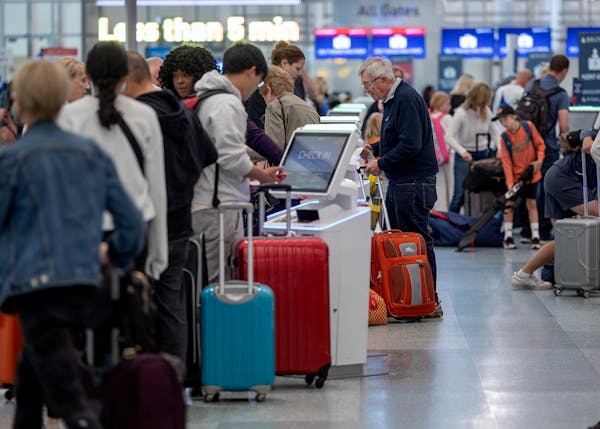 Travelers navigated the check-in kiosks at Terminal 1 at the Minneapolis-St. Paul International Airport on Thursday.