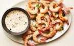 Elevate shrimp cocktail by roasting the shrump, not poaching them. And forgo cocktail sauce for a creamy horseradish remoulade.