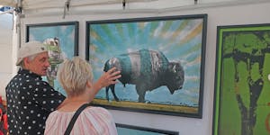 Patrons discuss artwork at the Loring Park Art Festival