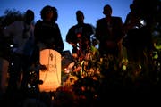 The family of George Floyd congregated around his tombstone at the “Say Their Names Cemetery” in Minneapolis on Thursday.