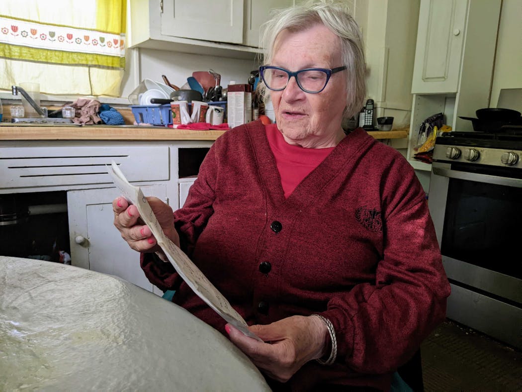 Joy Rindels-Hayden, seated in her kitchen recently, read her bill that improves bus safety for Minnesotans with disabilities. 