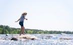Alicen Bauer, 13, crosses the headwaters of the Mississippi River Friday, May 26, 2023, at Itasca State Park in Park Rapids, Minn.