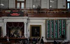 The voting board is lit with a majority of green lights as the house votes to impeach state Attorney General Ken Paxton, in the House Chamber at the T