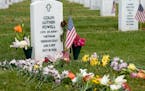 Flowers rest at the burial plot of former Secretary of State Colin Powell in Section 60 at Arlington National Cemetery on Memorial Day, Monday, May 29