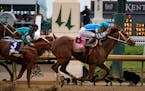 Mage (8), with Javier Castellano aboard, across the finish line to win the 149th running of the Kentucky Derby horse race at Churchill Downs Saturday,