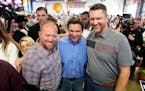 FILE - Florida Gov. Ron DeSantis, center, poses for a photo with audience members during a fundraising picnic forRep. Randy Feenstra, R-Iowa, May 13, 
