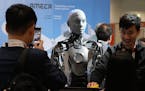 A robot designed by Engineers Arts and called AMECA, interacts with visitors during the International Conference on Robotics and Automation ICRA in Lo