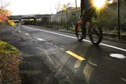 A bicyclist rode on the Midtown Greenway.