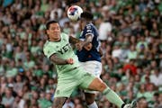 Austin FC midfielder Sebastián Driussi, left, contested for the ball against Vancouver Whitecaps defender Javain Brown on April 15, 2023.