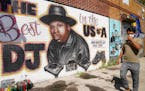 FILE - A pedestrian passes a mural of rap pioneer Jam Master Jay of Run-DMC, by artist Art1Airbrush, Aug. 18, 2020, in the Queens borough of New York.