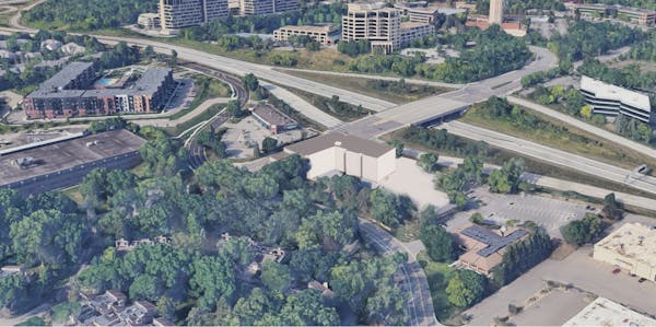An early-stage rendering of a proposed middle-income apartment in western Edina. The interchange of Highway 169 and Bren Road is behind the building.