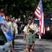 Members of the Pilgrim Baptist Church Troop 61 Boy Scouts led the flag ceremony at the start of the 34th annual Rondo Days Parade along Central Avenue