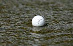Emiliano Grillo’s ball floats down a concrete drainage canal on the 18th hole during the final round of the Charles Schwab Challenge golf tournament