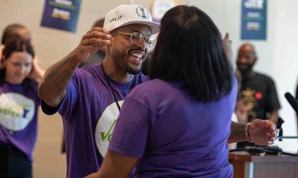 Antonio Williams, who is now eligible to vote, hugged a supporter after the new Minnesota law took effect June 1.