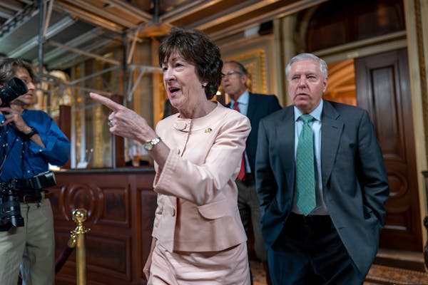 Days away from a default crisis, Sen. Susan Collins, R-Maine, center, and Sen. Lindsey Graham, R-S.C., leave a closed-door meeting with fellow Republi